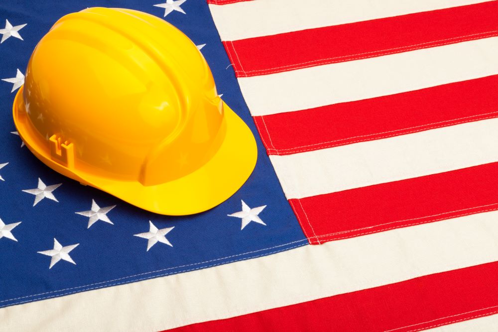 American flag with construction hat